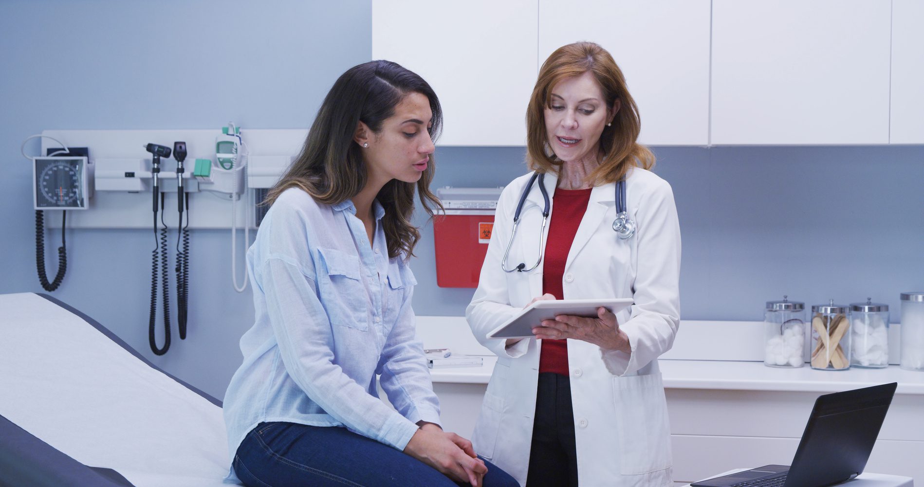 Patient discussing her health history with a practitioner during a first consultation